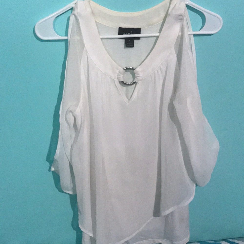 A white overlay and sleeved top